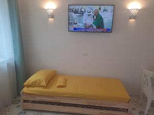 a bed in a room with a tv on the wall at Citronia Relax in Forio d'Ischia