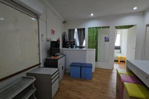 a room with a office with a desk and a room with a unintention at Kenyalang Saberkas Homestay in Miri