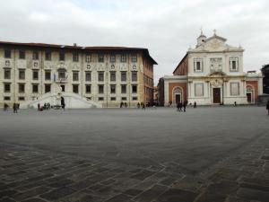 a large courtyard in a building with people walking around at Pisa Center in Pisa