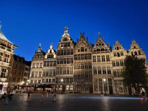 a large building with people standing in front of it at Plezantwerpen, Zuiderzin in Antwerp
