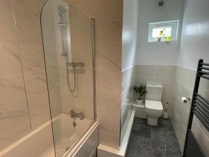 a bathroom with a shower and a toilet at Flat 2, 297 Gillott Road, B16 0RT in Birmingham +6 photos