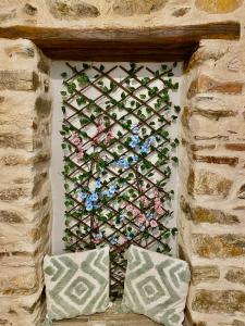 a wall with a bunch of plants on it at Porto Levante Anemos in Ermoupoli