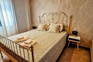 a bedroom with a large bed with pillows on it at Dúplex Chiclana Centro con Terraza y Parking By Chiclana Dreams in Chiclana de la Frontera