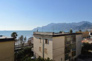 a building with the ocean in the background at B&B Al Golfo in Salerno