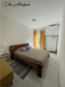 a bedroom with a bed and a table and a window at Vida Alentejana in Reguengos de Monsaraz