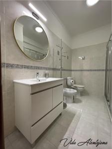 a bathroom with a sink and a mirror and a toilet at Vida Alentejana in Reguengos de Monsaraz