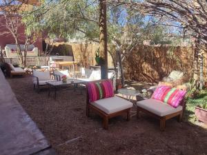 a group of chairs and tables in a yard at Tambo Norte in San Pedro de Atacama