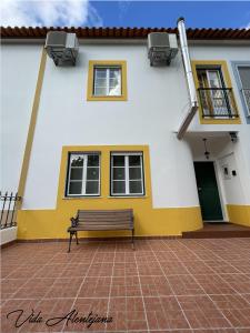 a bench sitting in front of a building at Vida Alentejana in Reguengos de Monsaraz