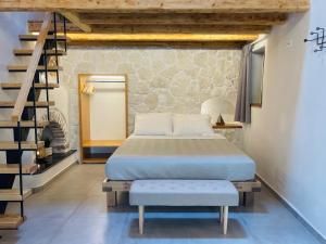 a bedroom with a bed and a stair case at Serenity Luxury Apartment in Symi