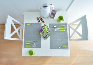 a table with flowers and other items on it at Split Center Room Helena in Split
