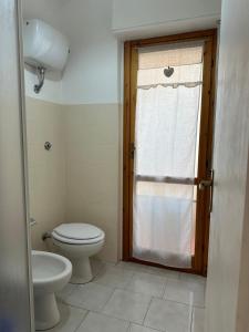 a bathroom with a toilet and a sink at Villaggio Malfidano in Buggerru