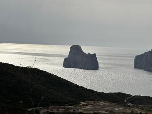 a large rock in the middle of the ocean at Villaggio Malfidano in Buggerru