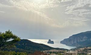 a view of a body of water with a mountain at Villaggio Malfidano in Buggerru