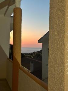 a view of the ocean from a balcony at sunset at Villaggio Malfidano in Buggerru