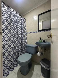 a bathroom with a blue toilet and a sink at Way Maker sede 2 in Bogotá +53 photos
