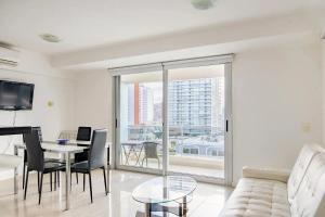 a living room with a couch and a table at Jamaica Punta del Este Hotel & Residence in Punta del Este