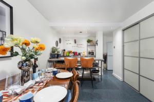 een eetkamer met tafels en stoelen en een keuken bij Westminster Classic Massionette in Londen