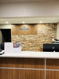 an atlantic line sign on a stone wall at AmericInn by Wyndham Glendale Milwaukee in Glendale