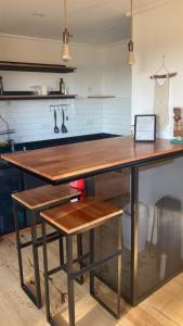 a kitchen with a large wooden table with two benches at Casita Petra in Tandil
