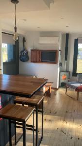 a living room with a wooden table and a couch at Casita Petra in Tandil