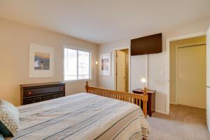 a bedroom with a bed and a dresser and a television at Flagstaff Townhome with Grill about 3 Mi to Downtown! in Flagstaff