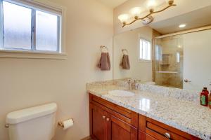a bathroom with a sink and a toilet and a mirror at Flagstaff Townhome with Grill about 3 Mi to Downtown! in Flagstaff +18 photos
