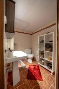 a bathroom with a white sink and a toilet at Catch n relax in Kalabaka