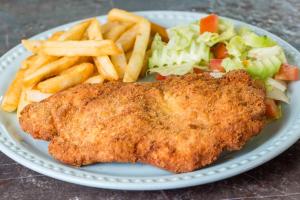 a plate of food with a fried fish and french fries at LOL-HA Hotel Boutique in Cancún