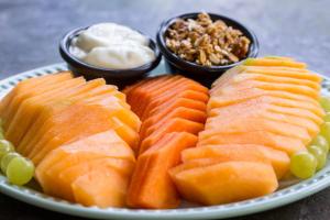 a plate of fish and grapes and dip and bowls of dips at LOL-HA Hotel Boutique in Cancún