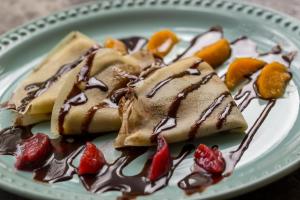 a plate of desserts with chocolate and fruit on it at LOL-HA Hotel Boutique in Cancún
