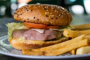 a sandwich and french fries on a plate at LOL-HA Hotel Boutique in Cancún