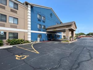 an empty parking lot in front of a building at AmericInn by Wyndham Glendale Milwaukee in Glendale