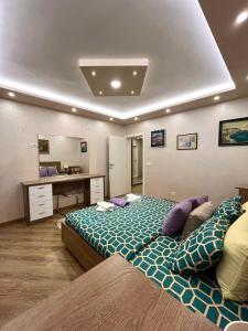a bedroom with a large bed and a desk at Sasa Plus in Bajina Bašta