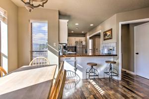 a kitchen with a counter and stools in a room at Modern Mountain Retreat with Views Ski, Golf and Hike in Angel Fire