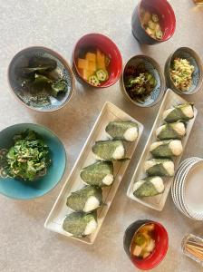 a table with plates of food and bowls of food at 民宿とランチ大ちゃんち in Shimanto