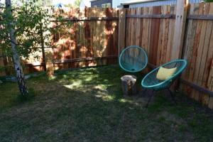 a yard with a chair and a mirror next to a fence at Birch Tree Studio in Braidwood