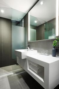 a bathroom with a white sink and a mirror at L7 HONGDAE by LOTTE HOTELS in Seoul +52 photos