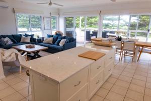a kitchen and living room with a couch and a table at 8 Downer Ave Goolwa South - No Linen Included in Goolwa South