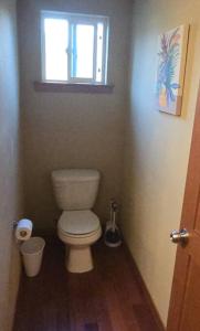 a small bathroom with a toilet and a window at Vibrant Living in Harmony, unit C in Seattle +4 photos