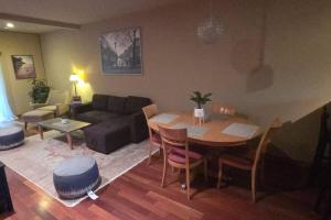 a living room with a table and a couch at Vibrant Living in Harmony, unit C in Seattle