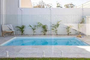 a swimming pool in the middle of a house at Free night! Pay for 2 stay for 3 in Narrawallee