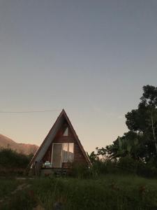 a small house sitting in the middle of a field at Rinjani Eger Bungalow in Sembalun Lawang