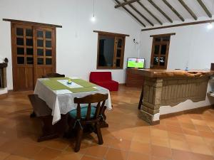 a living room with a table and a fireplace at Villas del Porvenir in Villa de Leyva