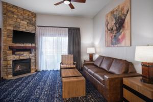 a living room with a couch and a fireplace at Club Wyndham Glacier Canyon in Lake Delton