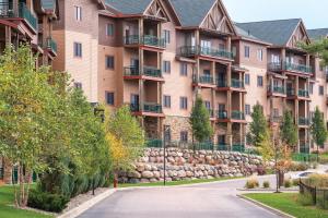 a road in front of a large apartment building at Club Wyndham Glacier Canyon in Lake Delton