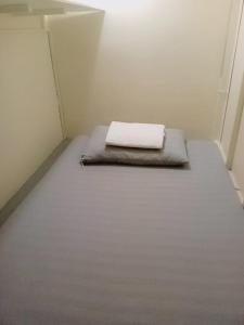 Postel nebo postele na pokoji v ubytování RDC- Baclaran Transient Capsule