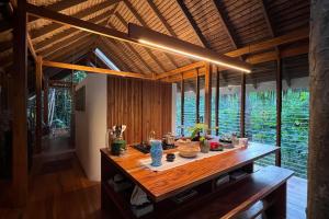 a kitchen with a wooden table in a house at Dalakit House Hidden Gem, Tranquility Nearby town in Siquijor
