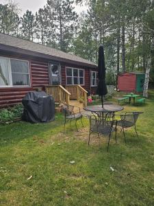 a yard with a table and chairs and a house at Butler's Bay Cottage cottage in Hayward