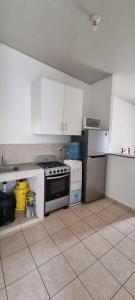 a kitchen with a stove and a refrigerator at Casa en Residencial MEGAPOLIS, San Miguel in San Miguel