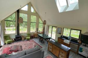 a living room with a couch and some windows at Number 8 - Castle Hill Village in Castle Hill